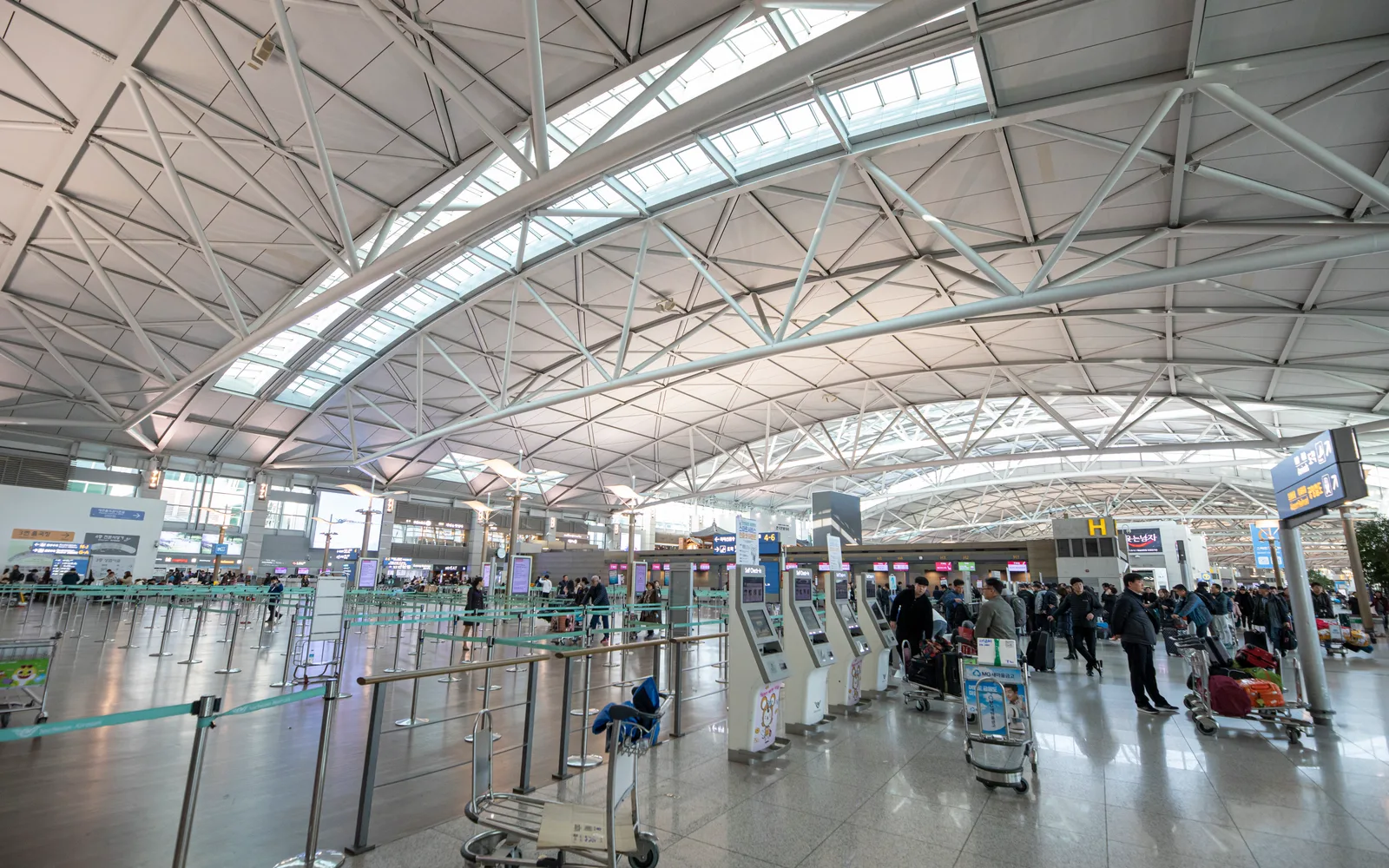 Incheon Airport Terminal 1 departure hall with check-in counters and passenger queues