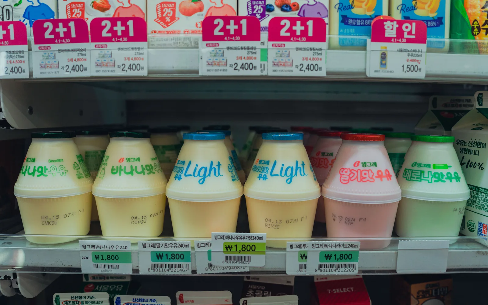 Bottled drinks and promotion labels in a Korean convenience-store refrigerator