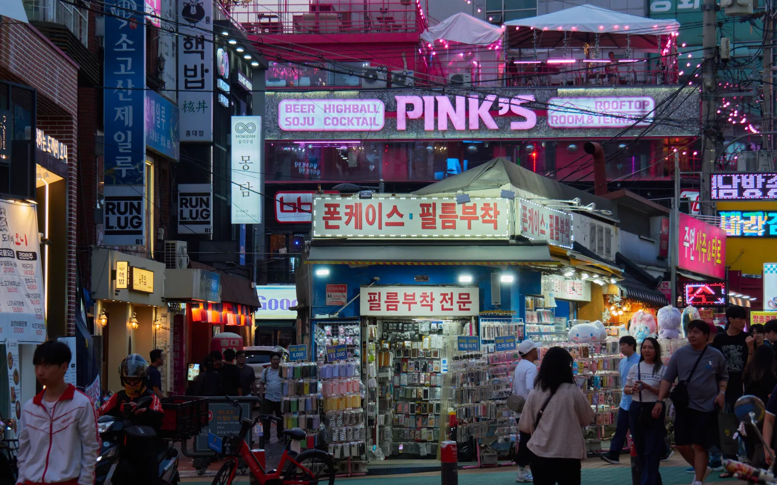 A busy neon-lit street in Hongdae