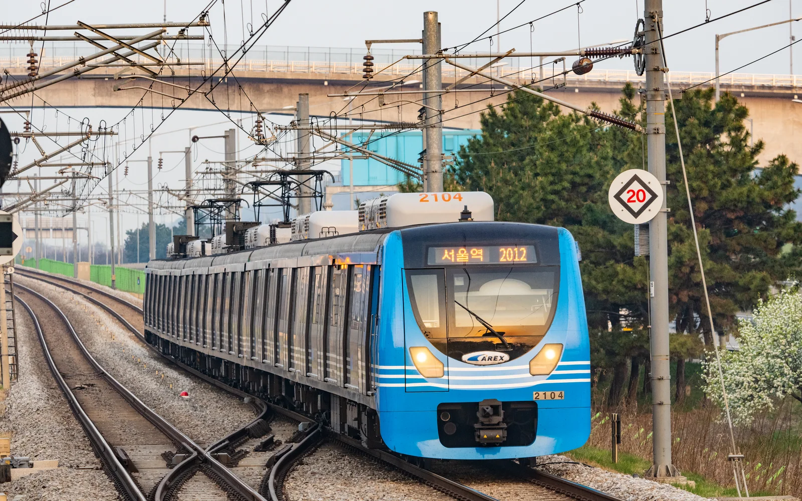 Blue AREX all-stop train traveling toward Seoul Station