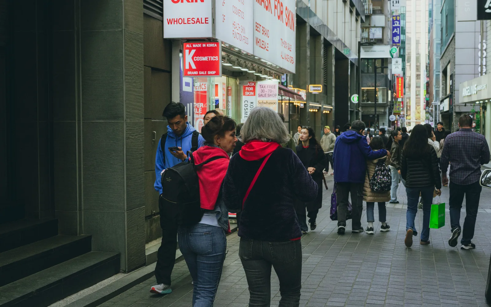 Crowded pedestrian shopping street in Myeongdong during the day