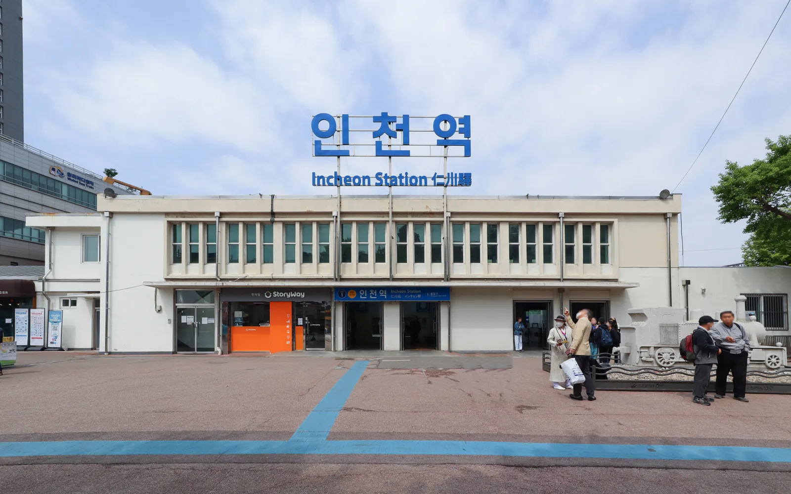 Front entrance of Incheon Station with its large blue Korean and English sign