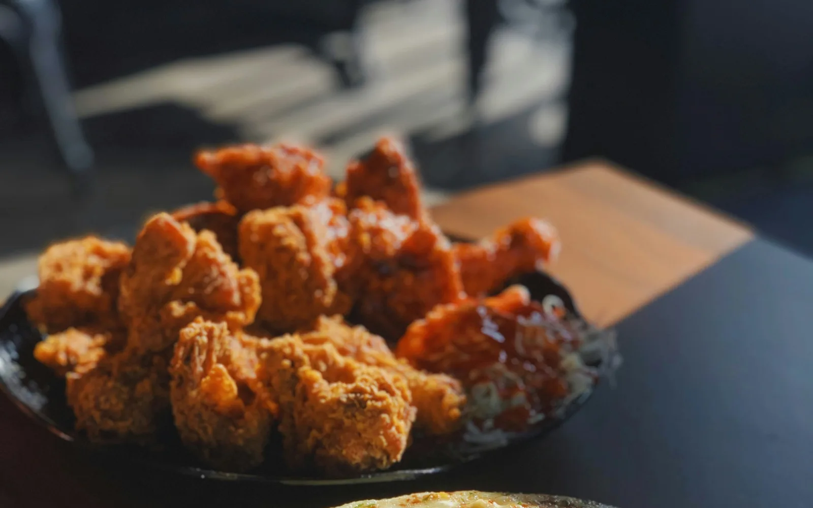 Plate of plain and sauced fried chicken used as a general food illustration