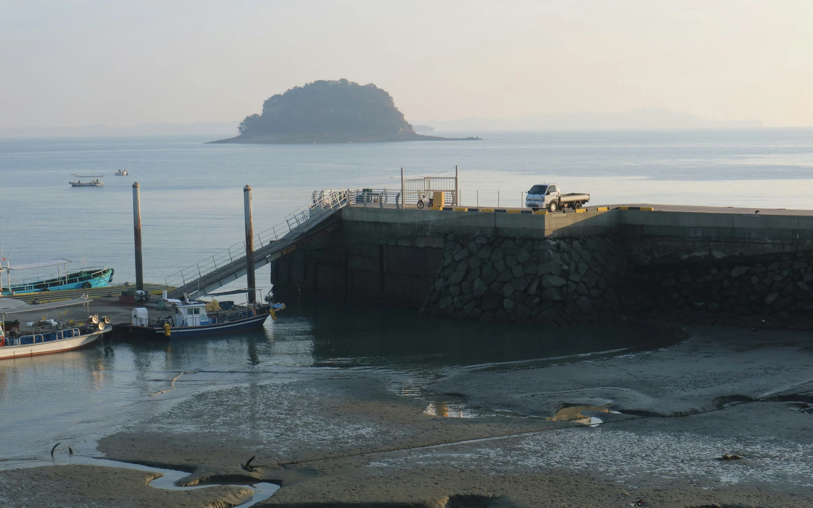 Fishing boats and a small offshore island viewed from Somuido harbor