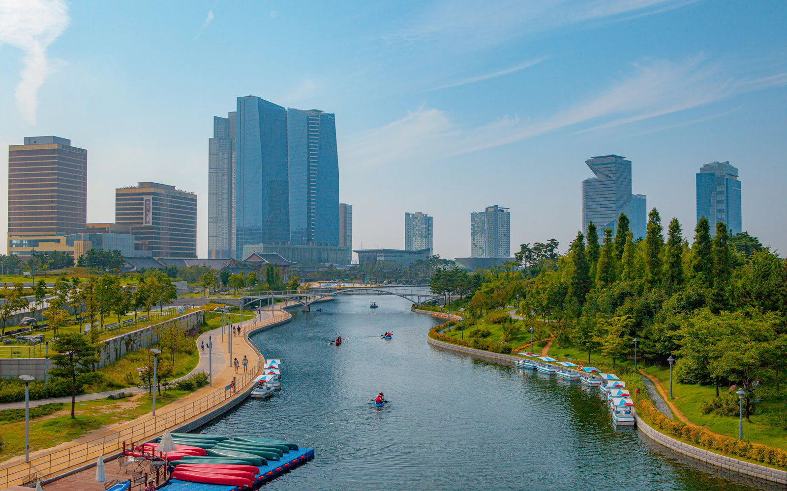 Songdo Central Park canal with walking paths, leisure boats and high-rise buildings