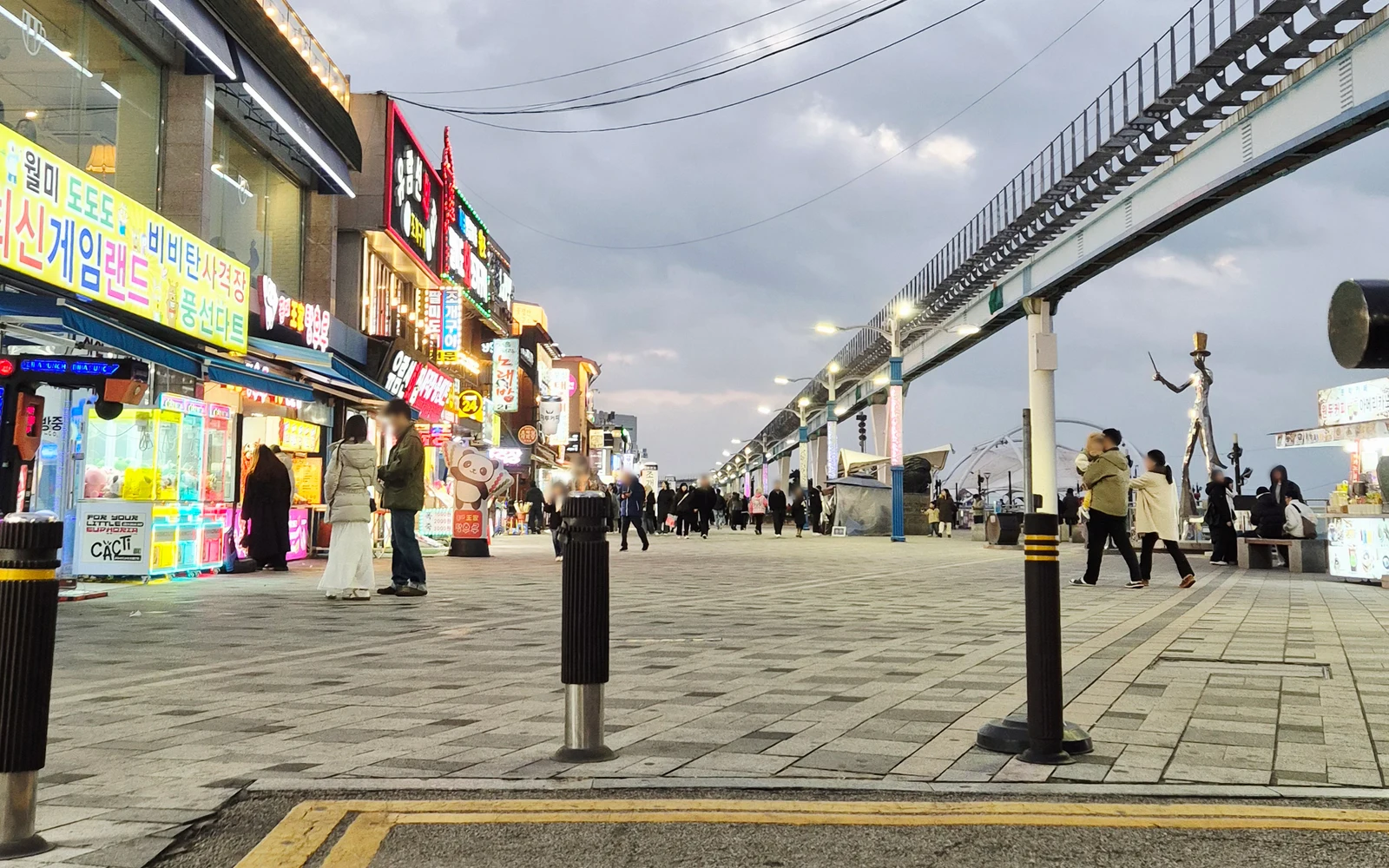 Evening shops and the elevated Sea Train track beside Wolmido Culture Street