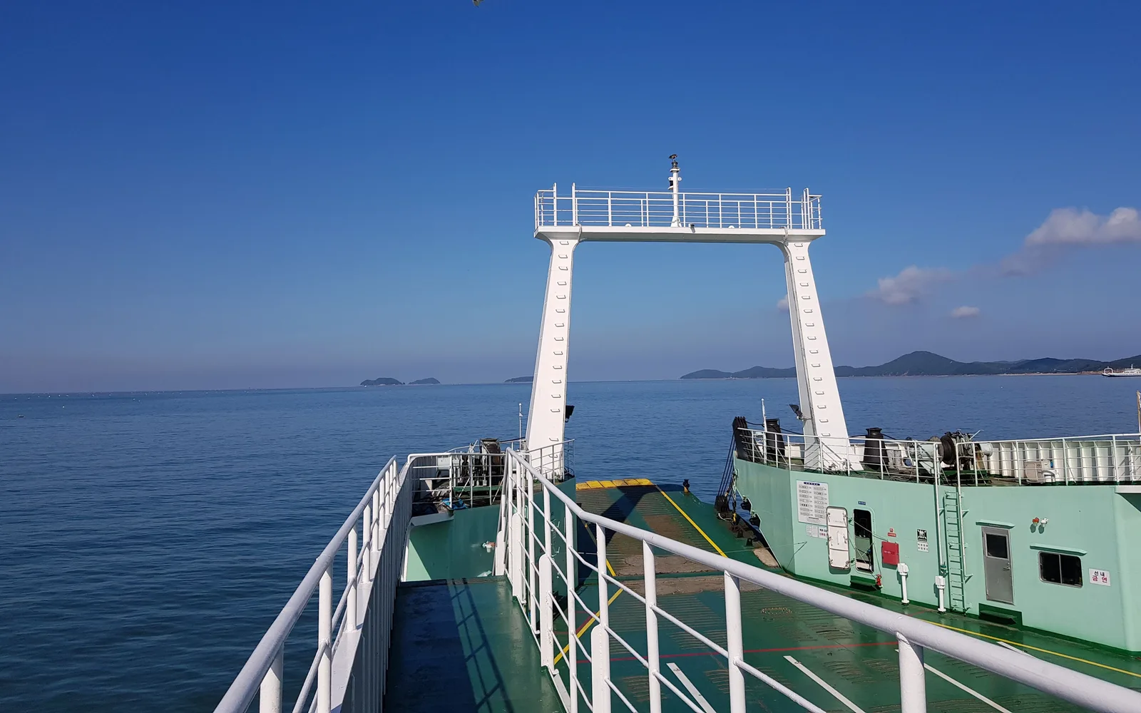 Open deck of a passenger ferry on the water in Incheon under a blue sky